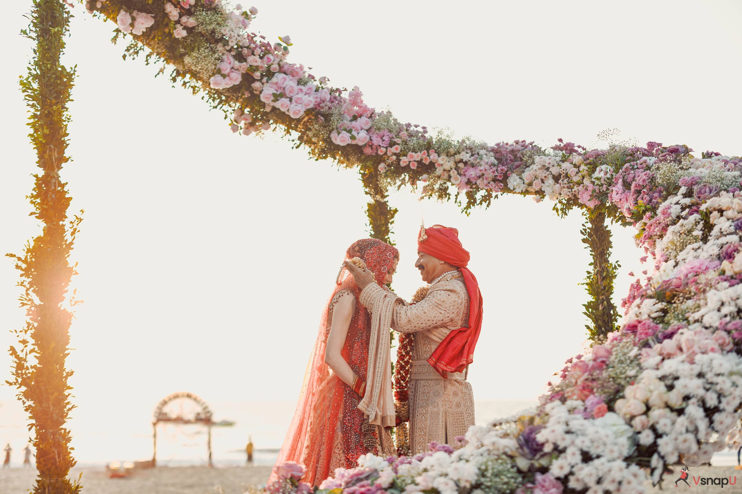 A joyful varmala ceremony as the couple locks eyes while exchanging floral garlands.
