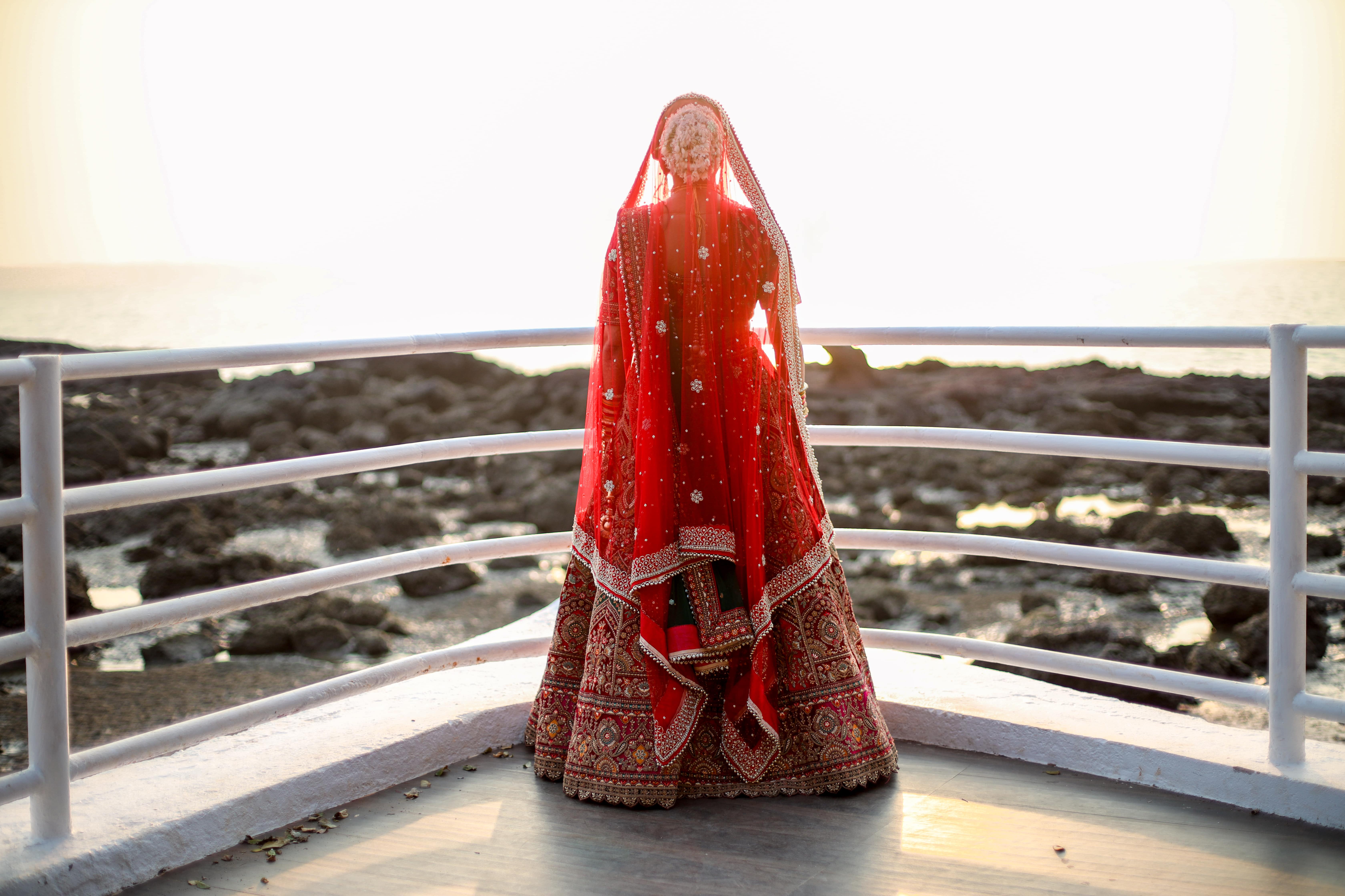 A breathtaking back shot of the groom basking in natural sunlight.